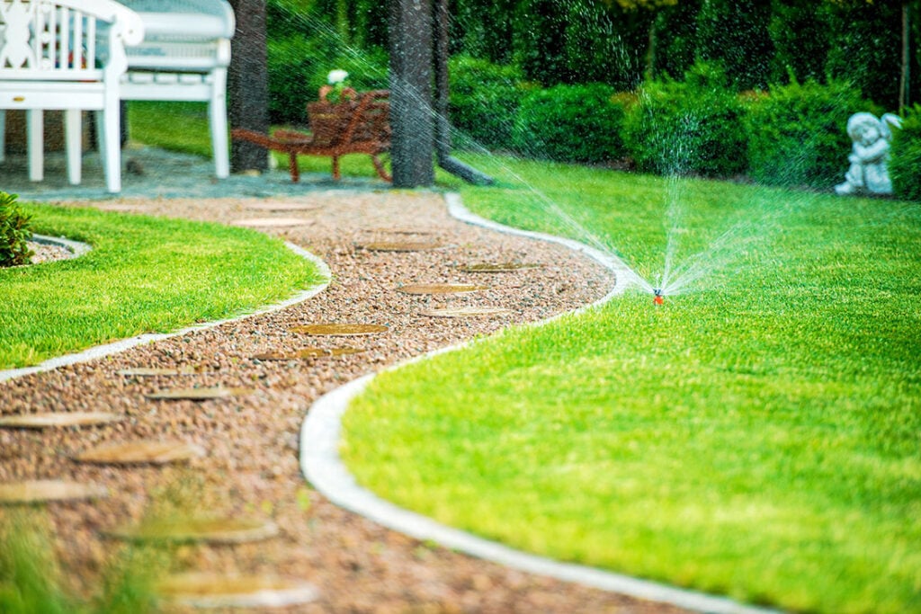 JTG Sprinkler Repair Davis County | JTG Plumbing Heating & Air | JTG Plumbing Heating & Air Adjusting sprinkler spray pattern for proper lawn watering during irrigation startup in Utah