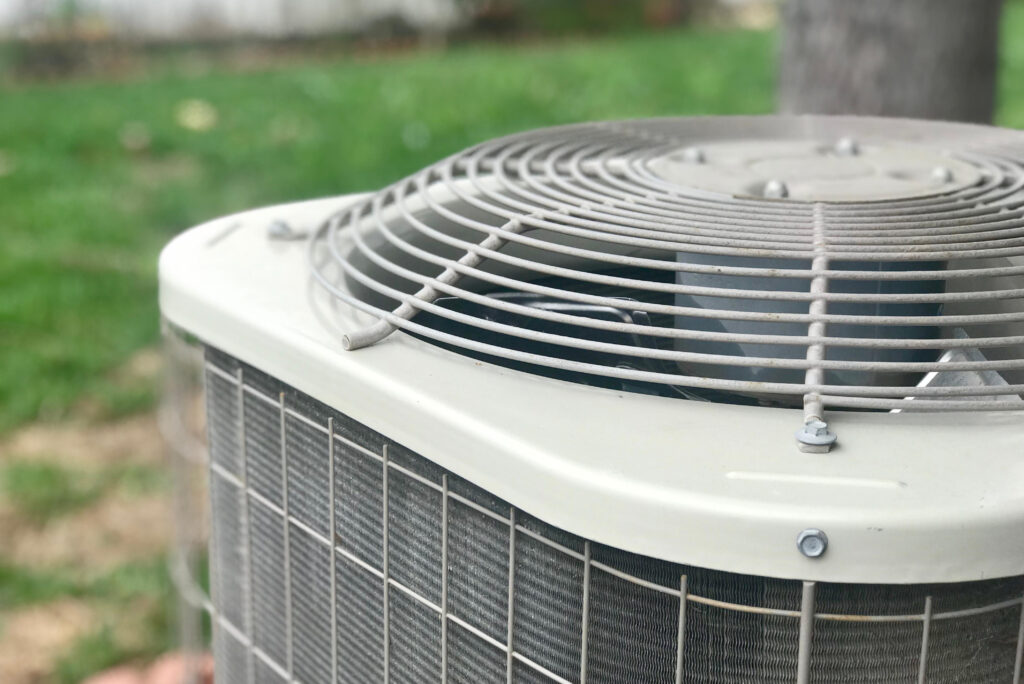 7 Common AC issues. AC Repair in Northern Utah | JTG Plumbing Heating & Air | JTG Plumbing Heating & Air AC technician from JTG Plumbing repairing air conditioner unit in Northern Utah home