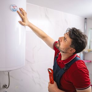 JTG Plumbing technician installing new water heater in Northern Utah home
